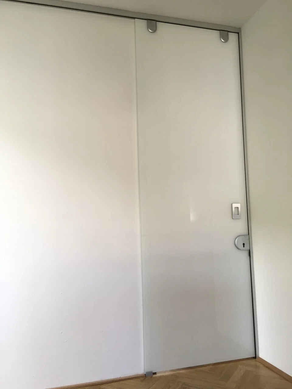 Glasschiebetür vor einem Mauerdurchgang in einem Wohnraum